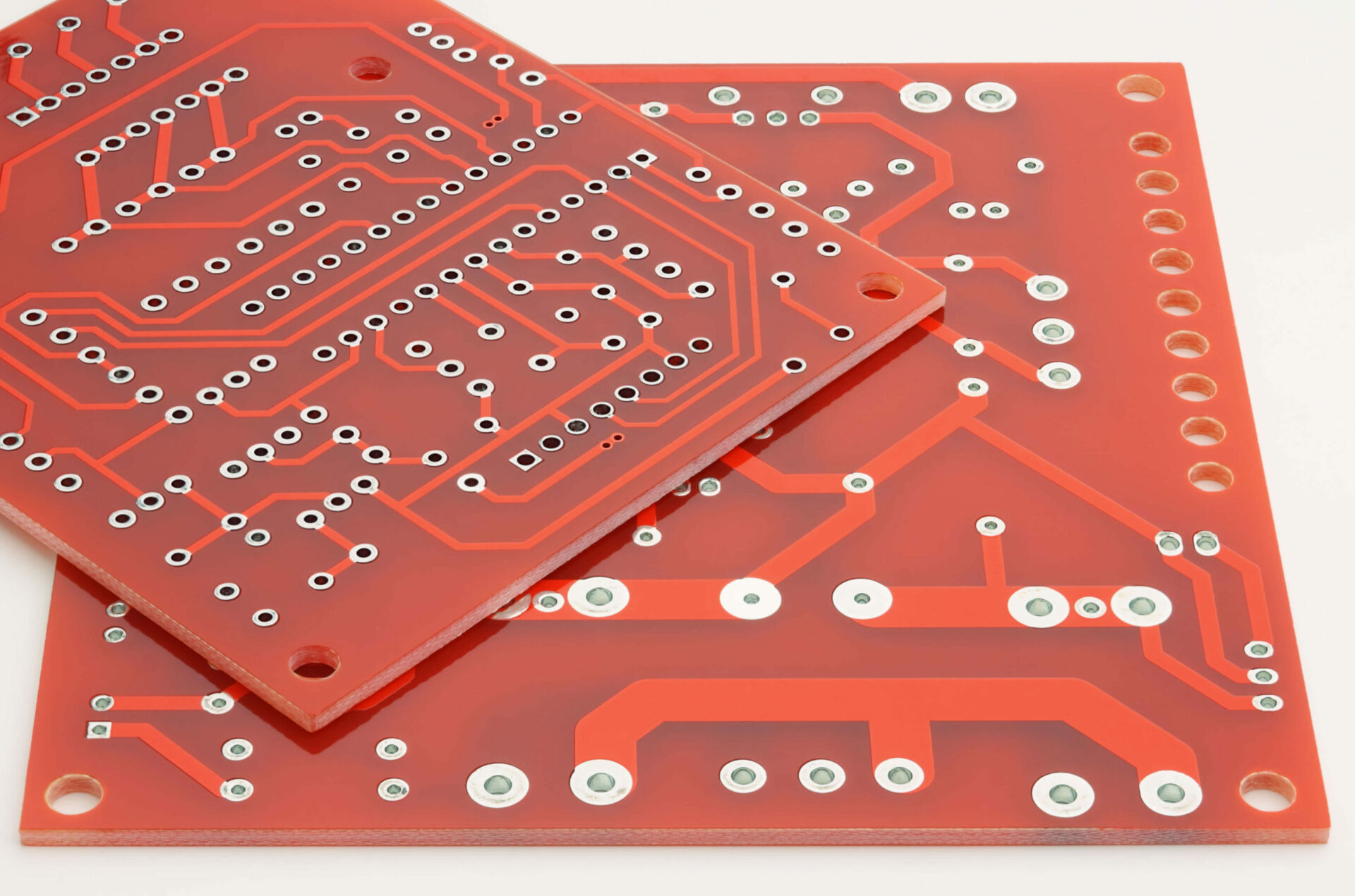 Photo of two red single sided PCBs